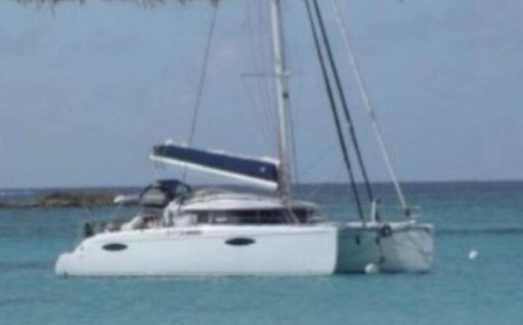 2009 Fountaine Pajot Orana 44 catamaran sailing on clear blue waters.