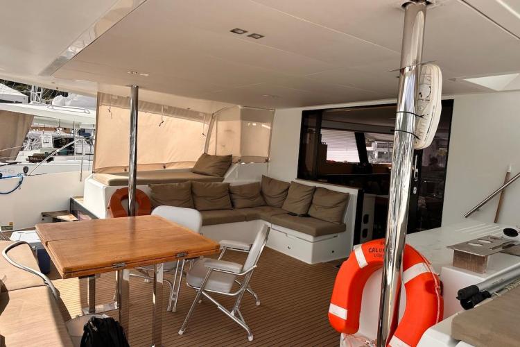 2016 Fountaine Pajot Ipanema 58 yacht interior with seating, table, and life preserver.