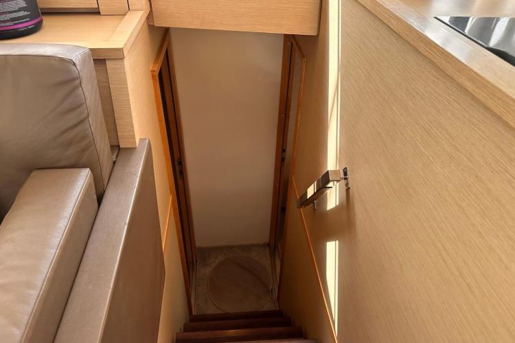Interior staircase of 2016 Fountaine Pajot Ipanema 58 yacht, featuring wooden finish.