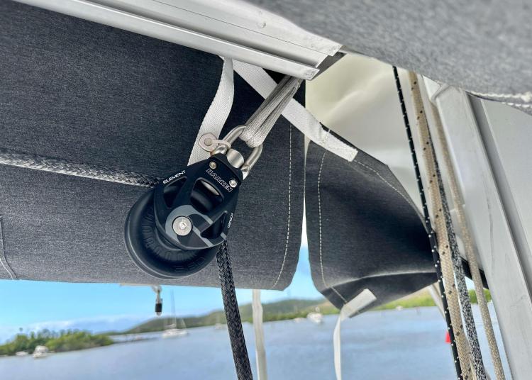 Close-up of 2023 Lagoon 46 sailboat rigging with scenic water background.