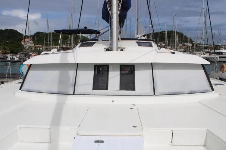 2017 Fountaine Pajot SABA 50 catamaran docked in a marina, showcasing sleek design and spacious deck.