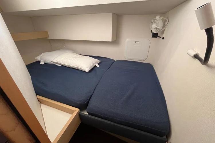 Cabin interior of 2017 Fountaine Pajot SABA 50 with blue bedding and white walls.