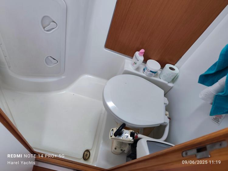 Bathroom interior of 2005 Beneteau Cyclades 43.3 yacht with toilet and toiletries.