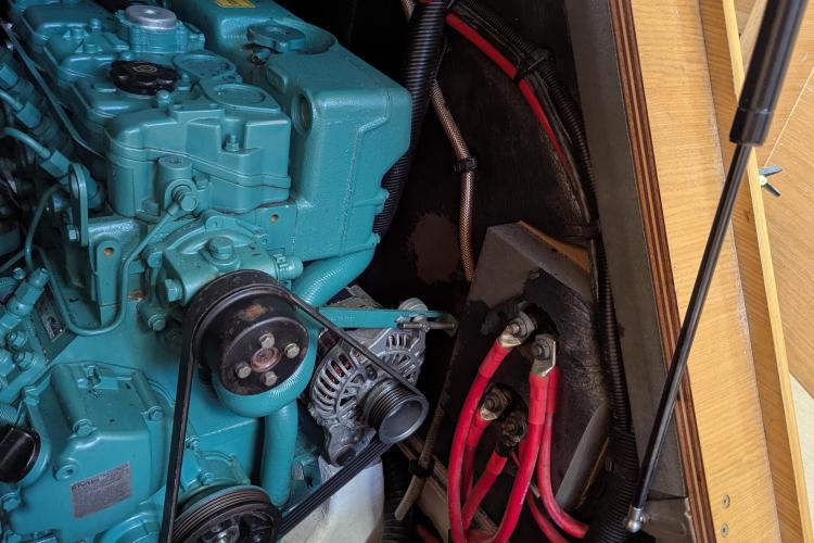 Engine compartment of a 2017 Dufour 460 Grand Large sailboat, featuring visible wiring and components.