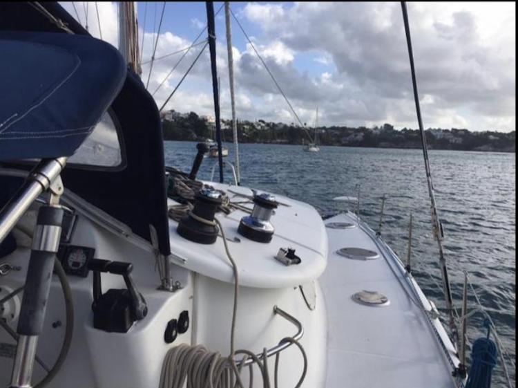 2009 Fountaine Pajot Orana 44 sailing on calm waters under cloudy skies.