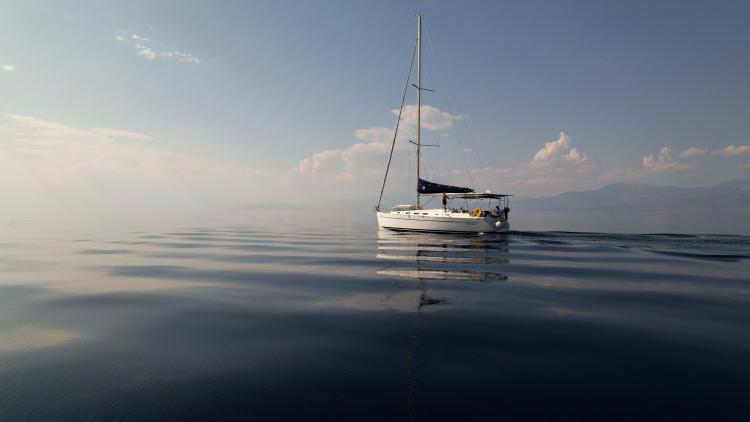 Sailboat Beneteau Cyclades 43.3, 2005 model, cruising on calm sea under clear sky.