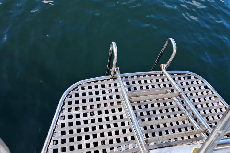 Stainless steel swim platform and ladder on 1986 Dufour CATALINA boat.