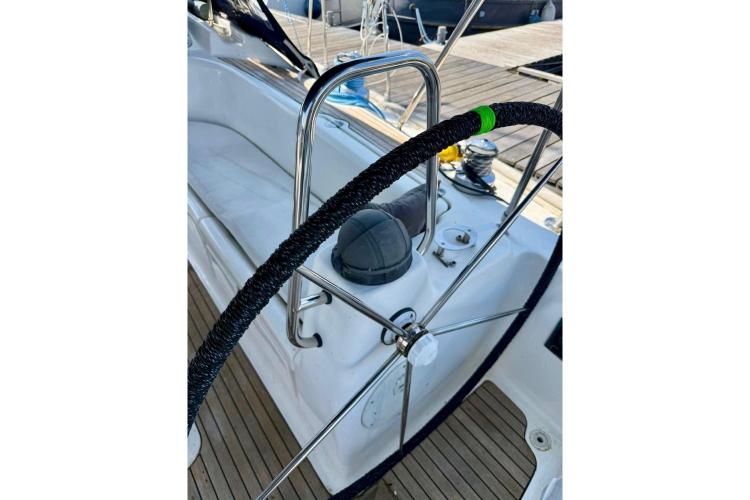 Steering wheel of a 2006 Bavaria Cruiser 46 yacht, docked at a marina.