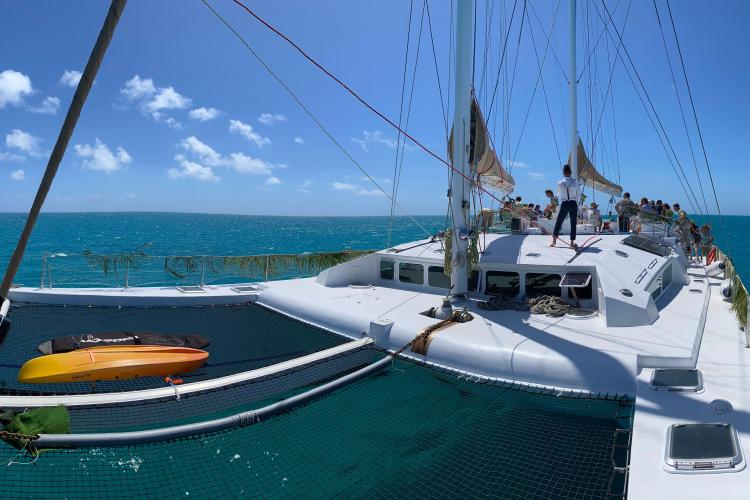 Sailing on Etoile Marine NAUTILUS 360 catamaran, 2004 model, with passengers enjoying the ocean view.
