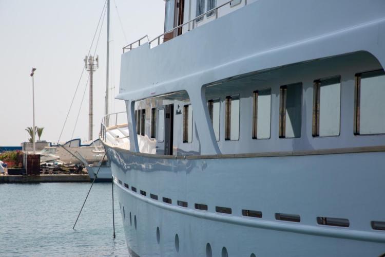 1972 Benetti 33 yacht docked in a marina, showcasing sleek design and windows.