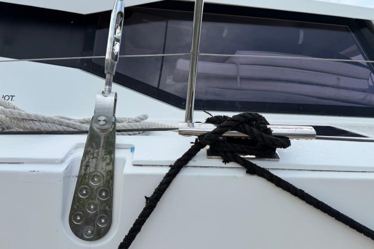 Close-up of a 2020 Fountaine Pajot Astrea 42 yacht's cleat with ropes secured.