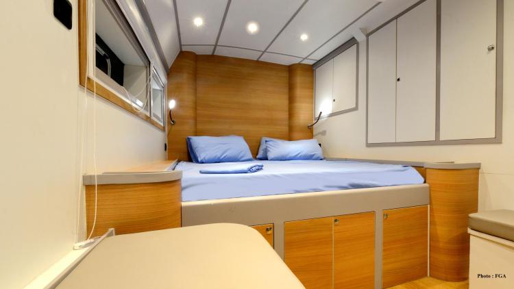 Luxurious cabin interior of 2019 Squalt Marine CK 64 yacht with cozy bed and modern design.