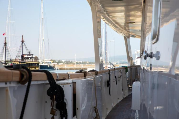 Side view of a 1972 Benetti 33 yacht docked at a marina.
