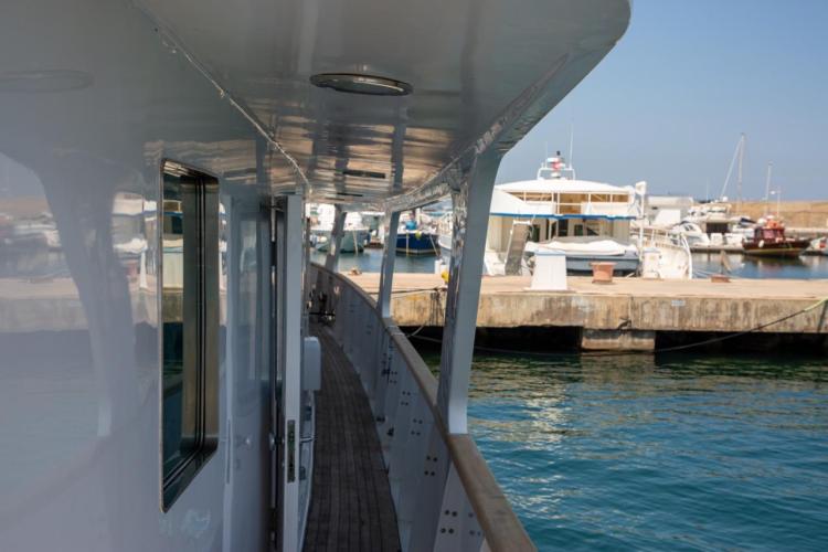 Side view of 1972 Benetti 33 yacht docked at a marina.