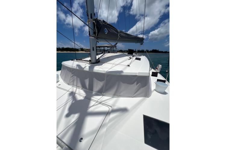 2023 Fountaine Pajot Astrea 42 Catamaran deck under sunny skies, sailing on blue waters.