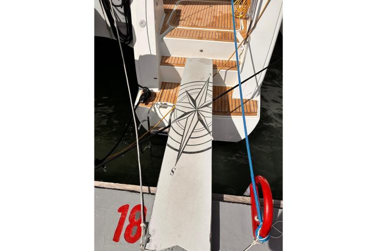 Boarding plank of 2016 Fountaine Pajot Ipanema 58 catamaran with compass design.