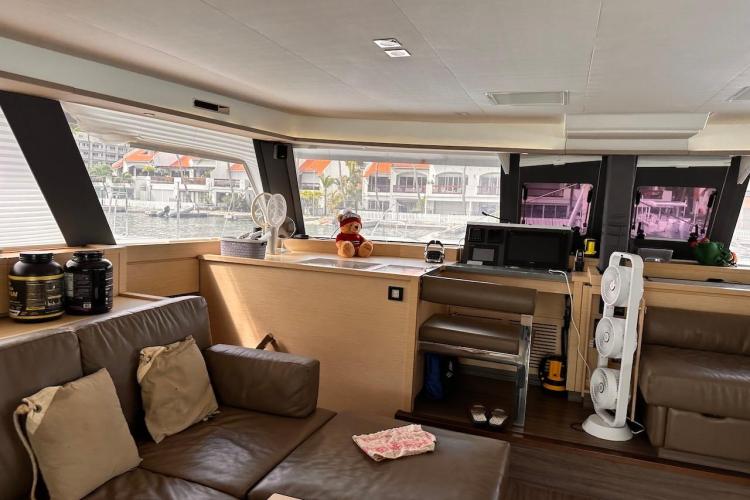 Interior of 2016 Fountaine Pajot Ipanema 58 yacht with modern furnishings and large windows.