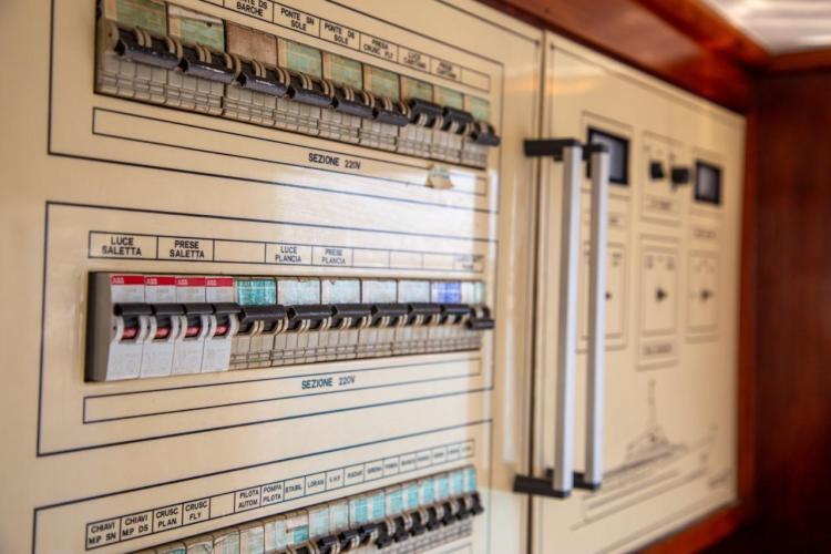 Electrical control panel on a 1972 Benetti 33 yacht, featuring labeled switches and circuits.