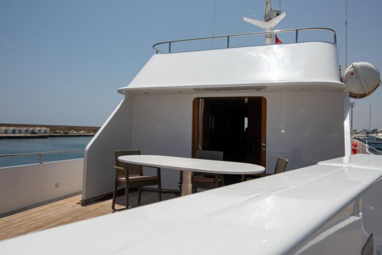1972 Benetti 33 yacht deck with seating area, overlooking calm marina waters.