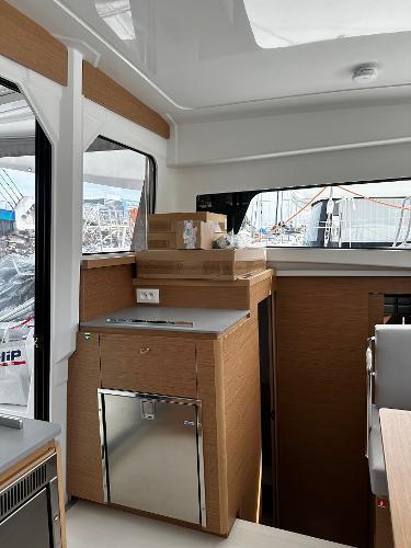 Interior of 2024 Excess 11 yacht with modern wood cabinetry and sleek design.