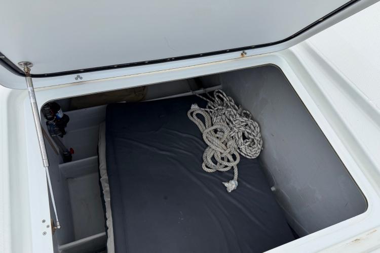 Storage compartment on a 2020 Fountaine Pajot Astrea 42 catamaran with rope and cushion.