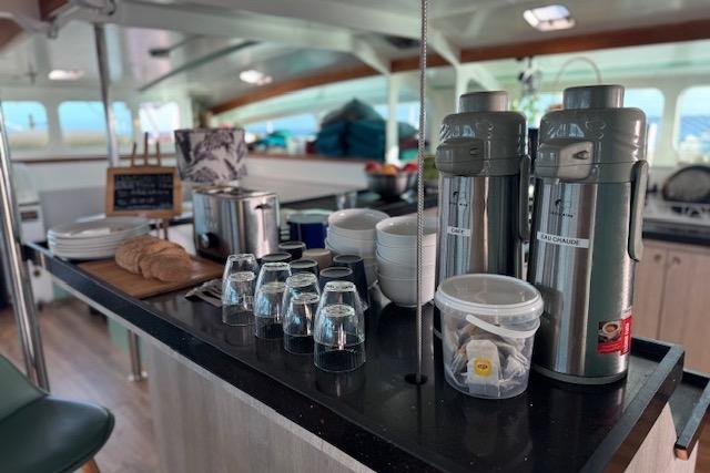 Cozy kitchen area on 2004 Etoile Marine Maxi Cat 24 with coffee setup and bread.