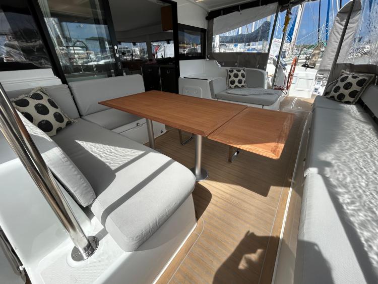 Luxurious 2024 Excess 14 yacht interior with comfortable seating and wooden table.