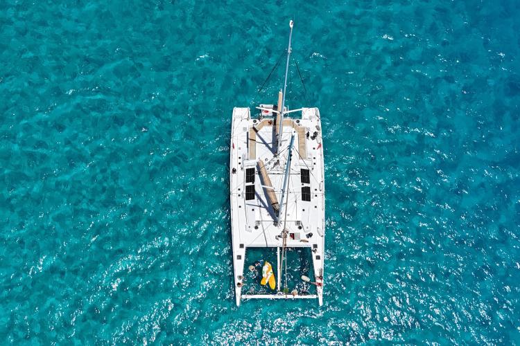Aerial view of Etoile Marine NAUTILUS 360 catamaran on clear blue water, 2004 model.