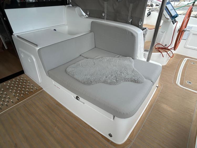 2024 Excess 14 yacht interior with cushioned seating and wooden flooring.