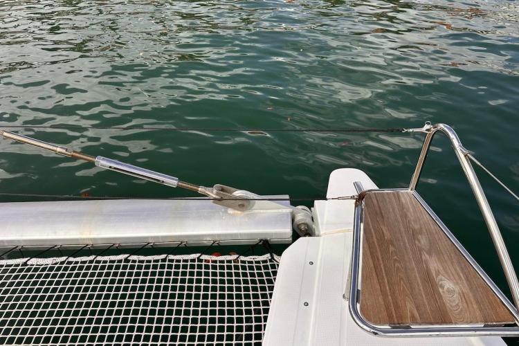 Deck of 2016 Fountaine Pajot Ipanema 58 catamaran with netting and water view.