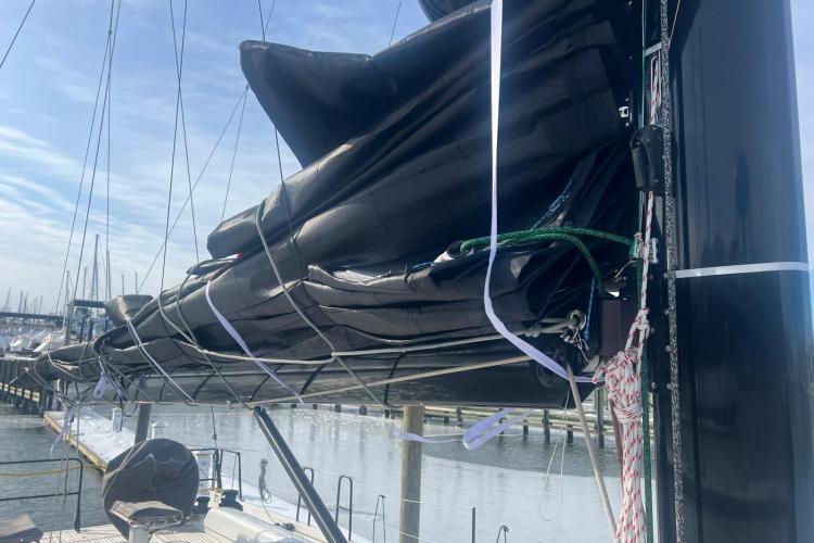 2024 Beneteau First 53 sailboat with neatly secured sails at a marina.