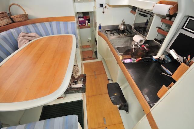 Interior of 2005 Custom Polynésie 42 yacht with kitchen and dining area.