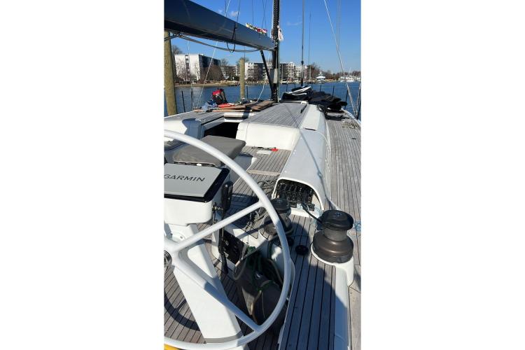 2024 Beneteau First 53 sailboat deck with steering wheel and Garmin navigation system.