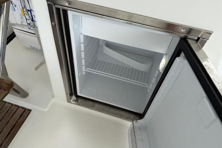 Open refrigerator on 2020 Fountaine Pajot Astrea 42 yacht, showcasing interior storage space.