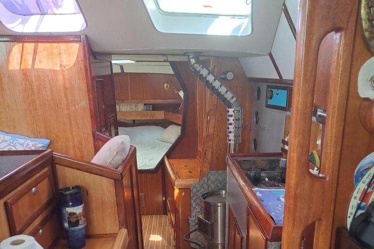 Interior of 2019 Custom Patago 40 yacht with wooden finish and cozy sleeping area.