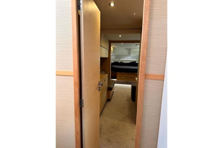 Interior view of 2016 Fountaine Pajot Ipanema 58 yacht cabin with bed and storage.