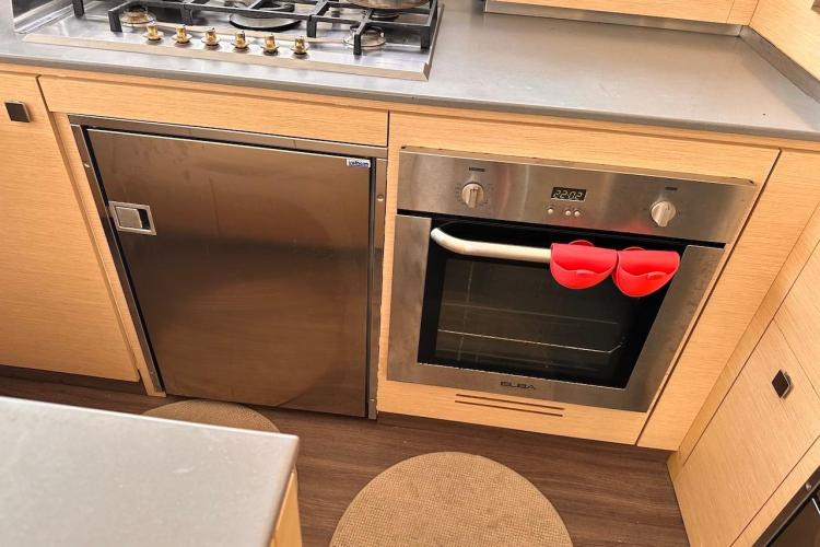 Modern kitchen in 2016 Fountaine Pajot Ipanema 58 yacht with oven and fridge.