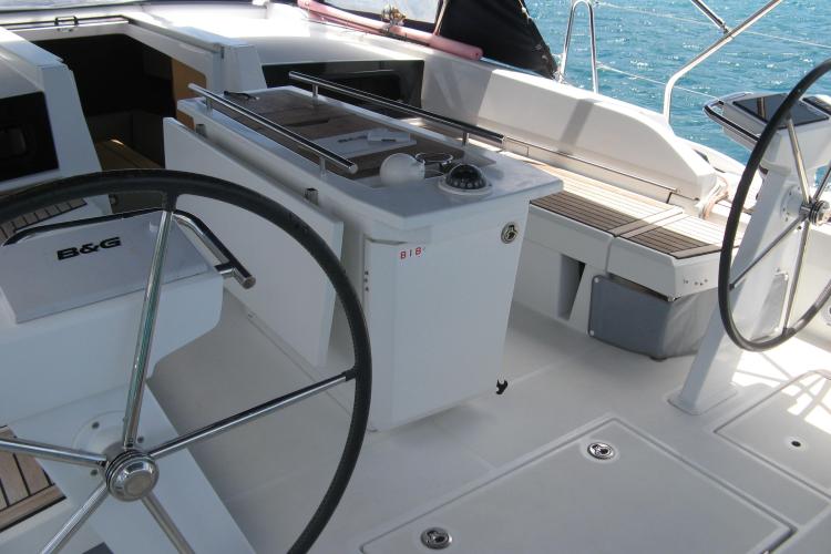 Cockpit of 2019 Beneteau Oceanis 46.1 sailboat with dual steering wheels and navigation equipment.