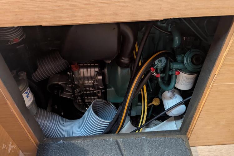 Engine compartment of a 2017 Dufour 460 Grand Large sailboat, showcasing mechanical components.