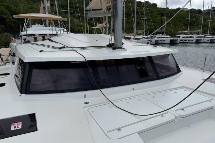 2020 Fountaine Pajot Astrea 42 catamaran docked, showcasing sleek design and spacious deck.