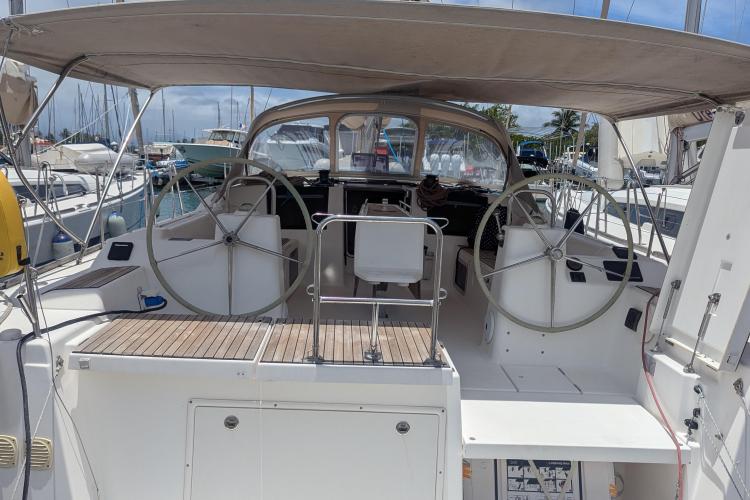 2017 Dufour 460 Grand Large yacht cockpit with dual steering wheels and canopy.
