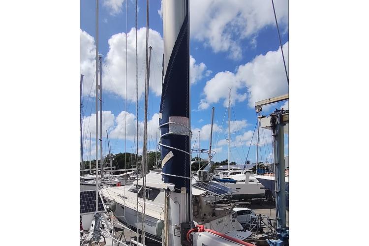 Jeanneau Sun Odyssey 37 sailboat from 2000 docked under a bright blue sky.