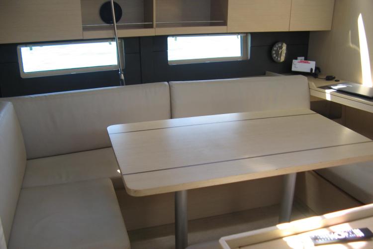 Interior of 2019 Beneteau Oceanis 46.1 yacht with cozy seating and dining area.