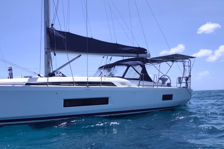 2019 Beneteau Oceanis 46.1 sailboat on clear blue water under a sunny sky.