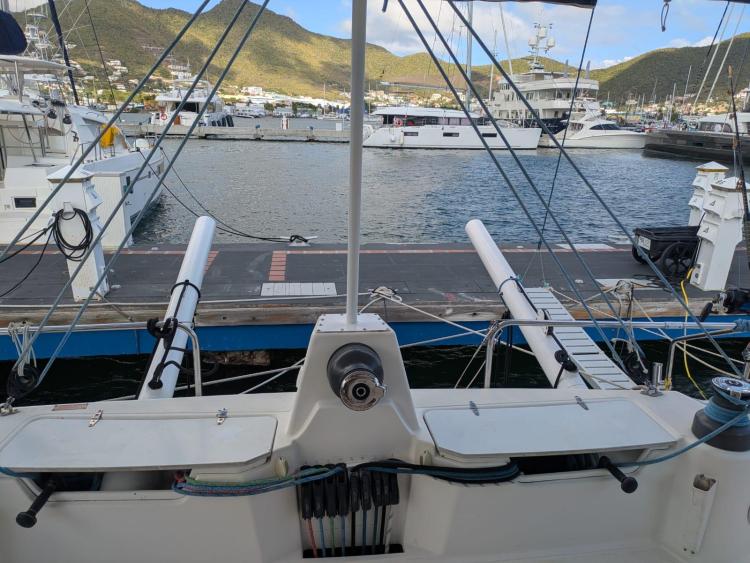 Catana 55 catamaran docked at marina, 2012 model, with scenic mountain backdrop.