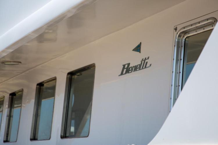 Close-up of 1972 Benetti 33 yacht exterior with logo and windows.