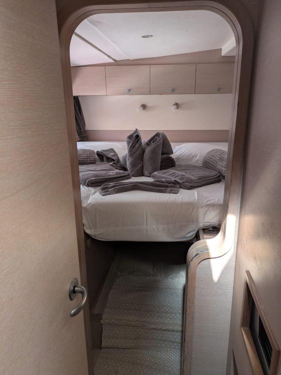Interior cabin of 2012 Catana 55 yacht with neatly arranged bed and towels.