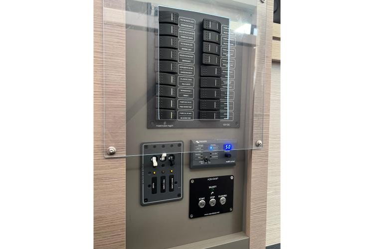 Electrical control panel on 2023 Fountaine Pajot Astrea 42 Catamaran, featuring switches and digital display.
