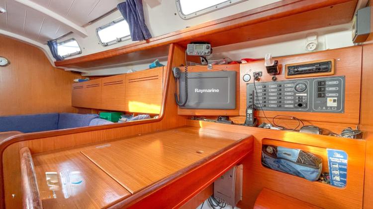 Interior of 2005 Beneteau Cyclades 43.3 yacht with navigation equipment and wooden cabinetry.