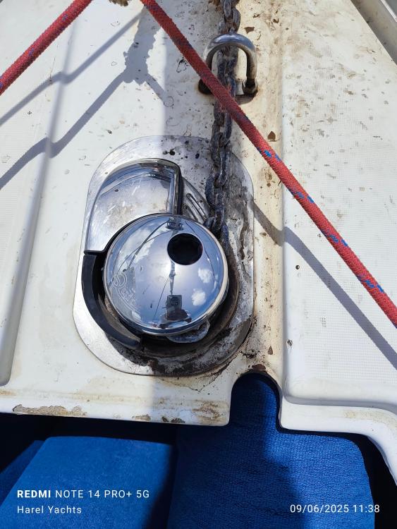 Anchor chain and winch on 2005 Beneteau Cyclades 43.3 yacht deck.